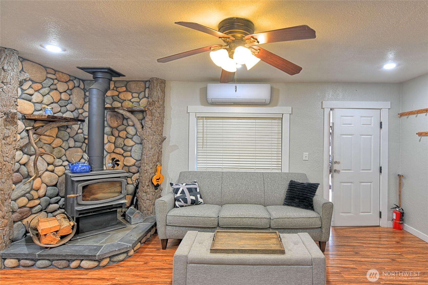 15421 Jim Creek Road Arlington, WA 98223 - Photo 4 of 27 a living room with furniture a chandelier and a fireplace