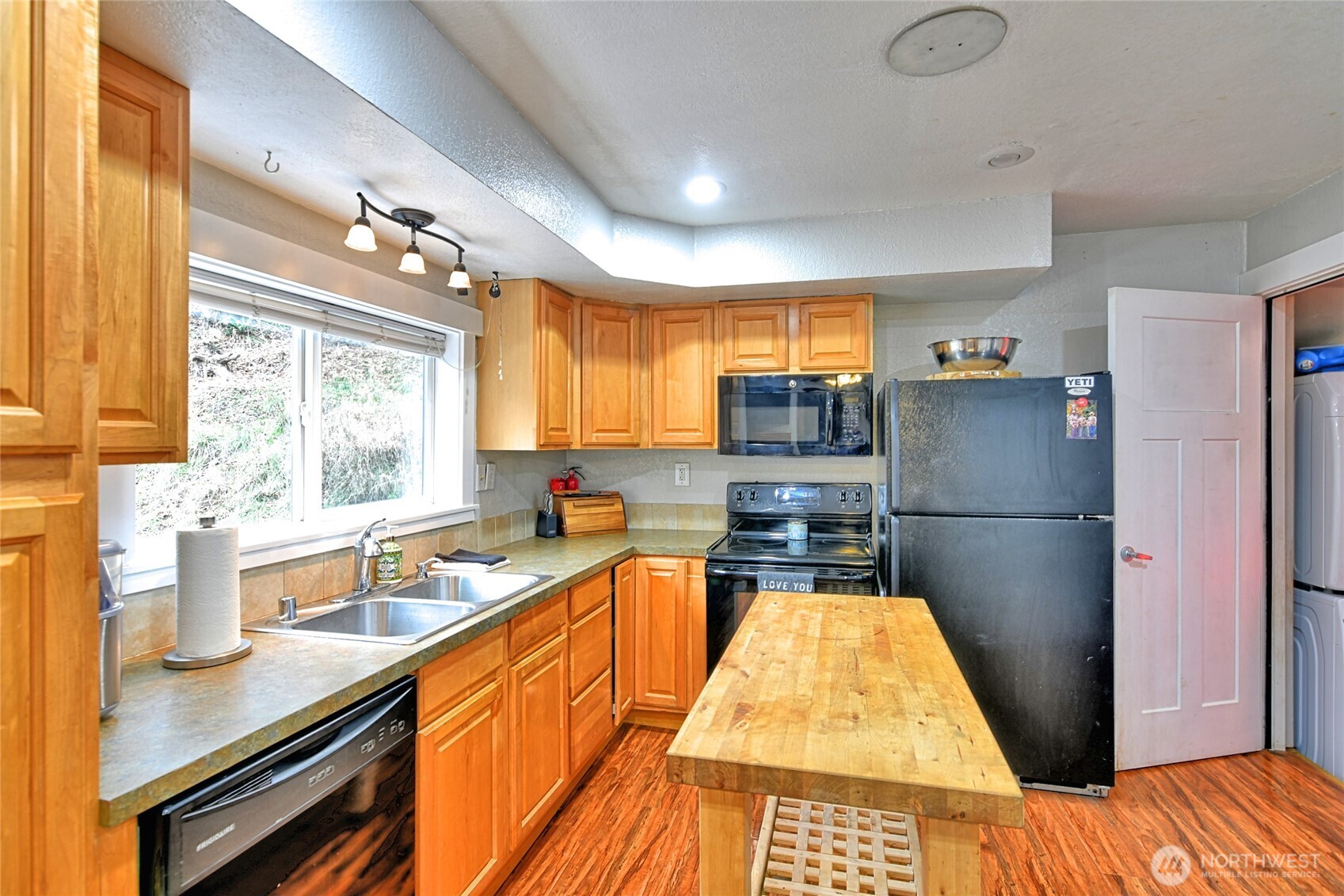 15421 Jim Creek Road Arlington, WA 98223 - Photo 5 of 27 a kitchen with stainless steel appliances a stove a sink dishwasher and cabinets with wooden floor