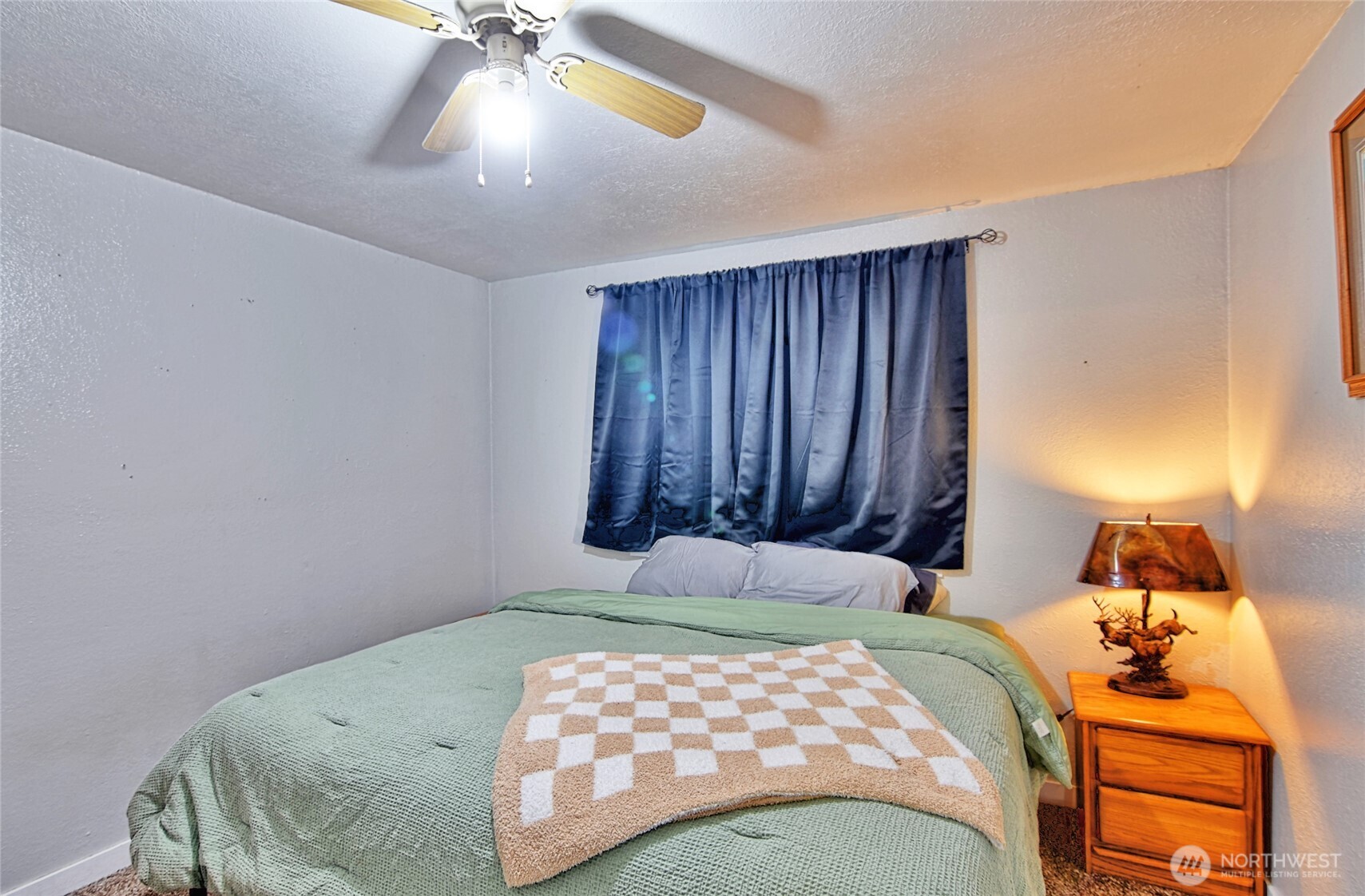 15421 Jim Creek Road Arlington, WA 98223 - Photo 9 of 27 a bedroom with a bed and a chandelier