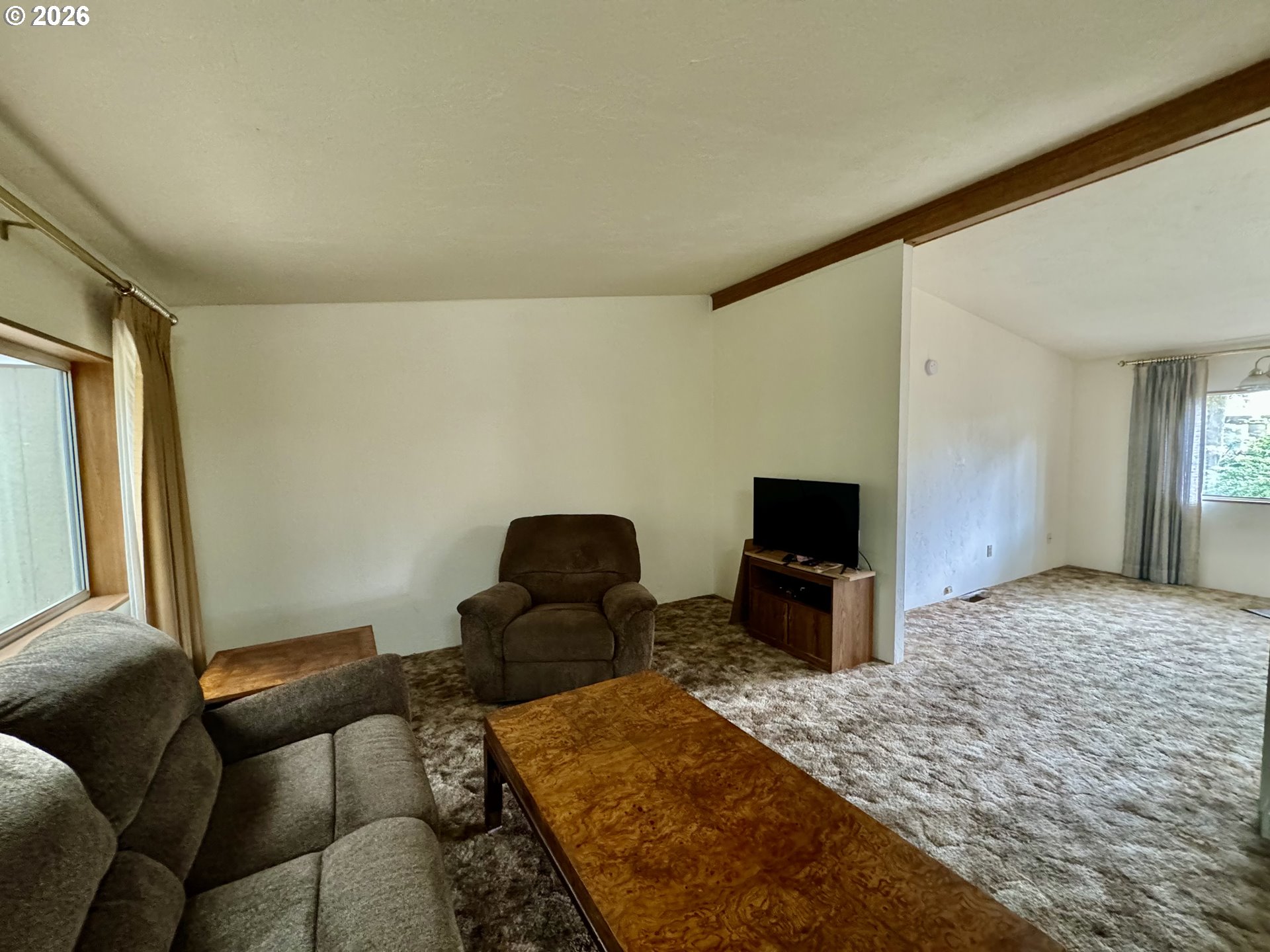 1600 Rhododendron Drive, Unit 245 Florence, OR 97439 - Photo 12 of 47 a living room with furniture and a flat screen tv