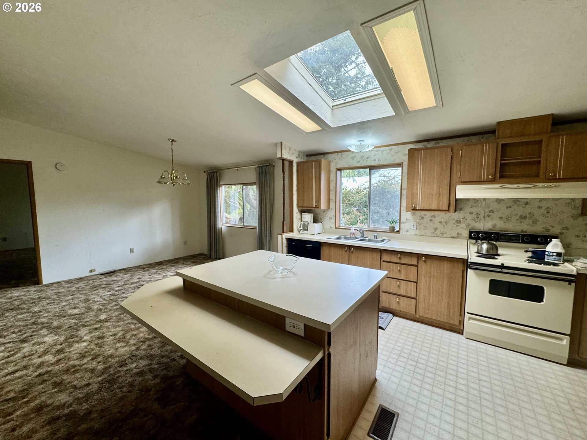 1600 Rhododendron Drive, Unit 245 Florence, OR 97439 - Photo 15 of 47 a kitchen with a stove a sink dishwasher and a refrigerator