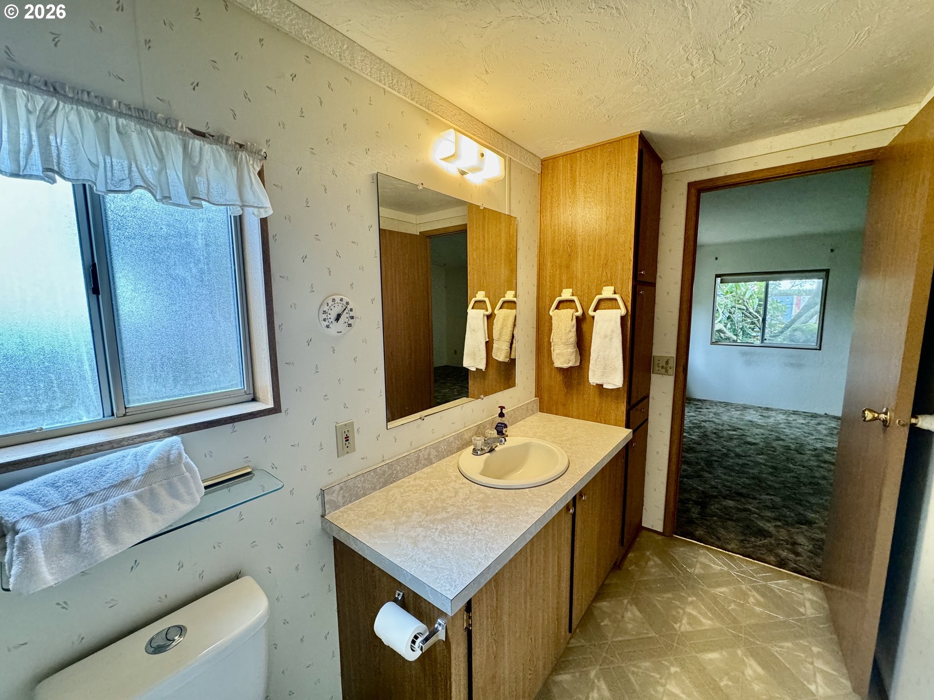 1600 Rhododendron Drive, Unit 245 Florence, OR 97439 - Photo 24 of 47 a bathroom with a sink a mirror and a bathtub