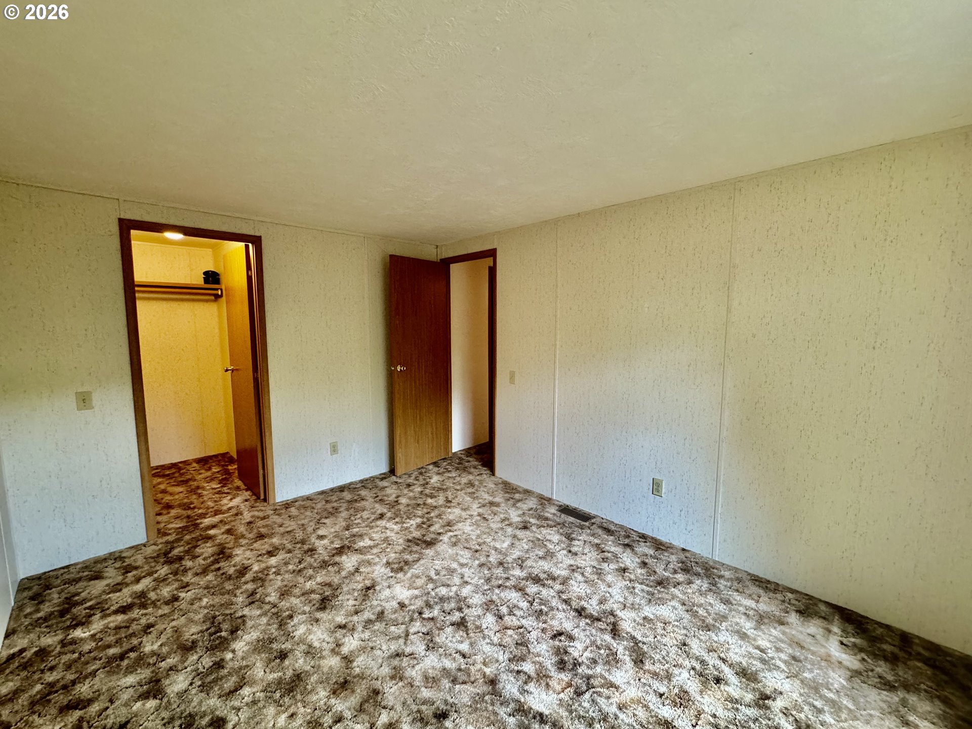 1600 Rhododendron Drive, Unit 245 Florence, OR 97439 - Photo 28 of 47 a view of a room with an empty space and wooden floor