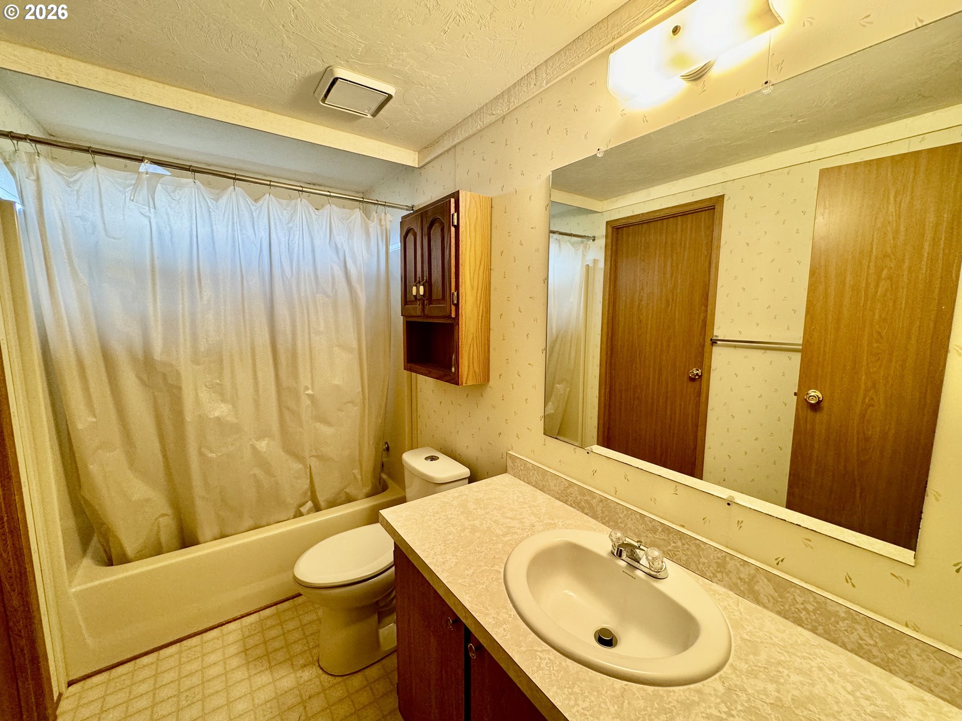 1600 Rhododendron Drive, Unit 245 Florence, OR 97439 - Photo 29 of 47 a bathroom with a sink a toilet and shower curtain