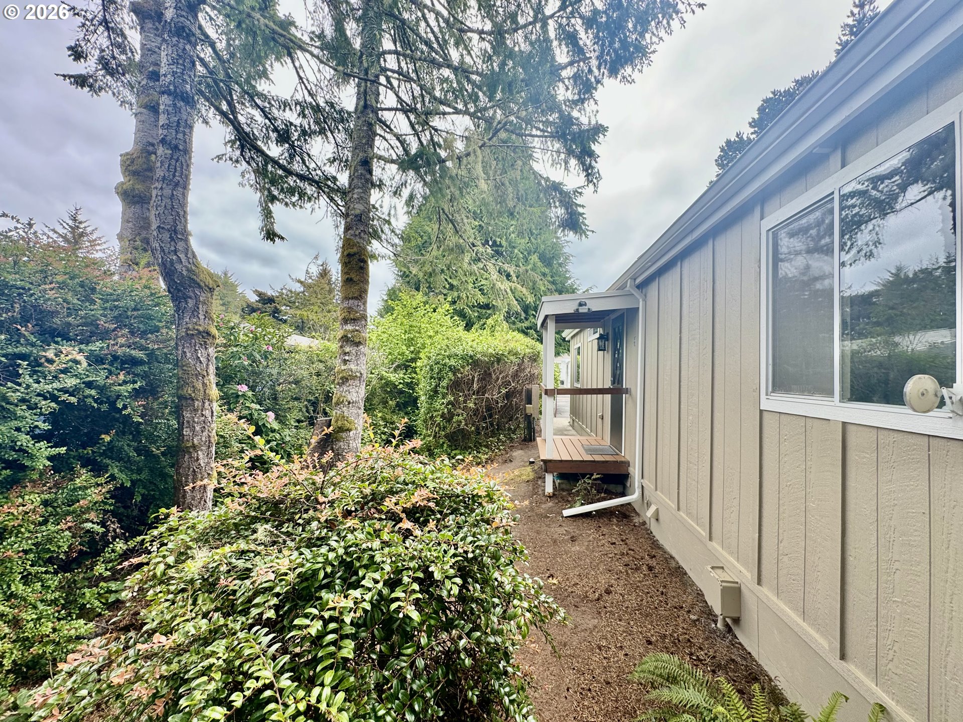1600 Rhododendron Drive, Unit 245 Florence, OR 97439 - Photo 45 of 47 a backyard of a house with lots of green space