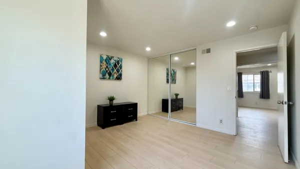 a living room with closet and furniture