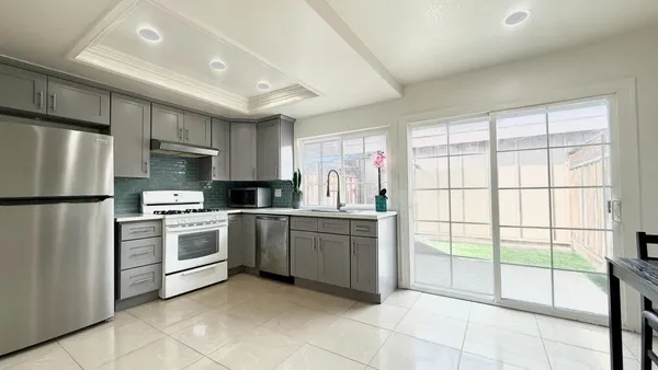 a kitchen with a refrigerator and a sink