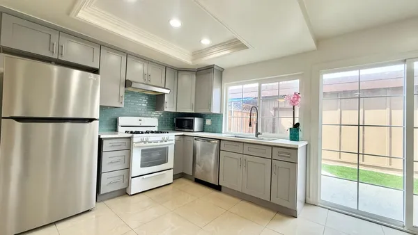 a kitchen with a sink a refrigerator and window