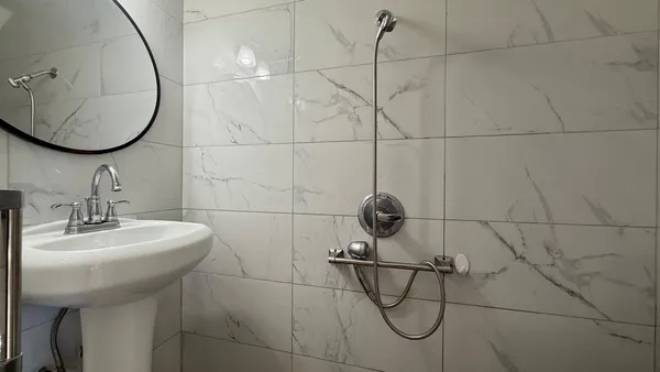 a bathroom with a sink toilet and mirror