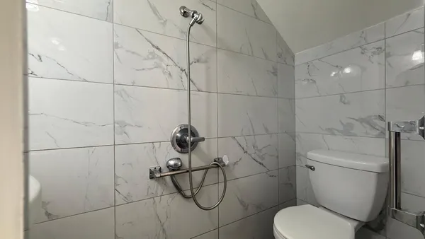a bathroom with a toilet and a shower