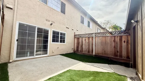 a view of a backyard with wooden fence