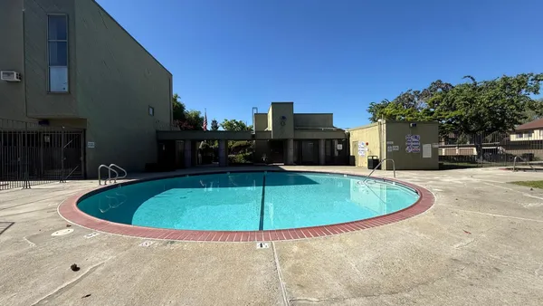 a swimming pool with outdoor seating and yard