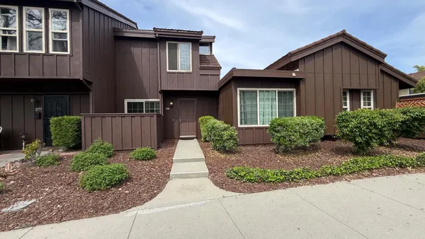 a front view of a house with garden