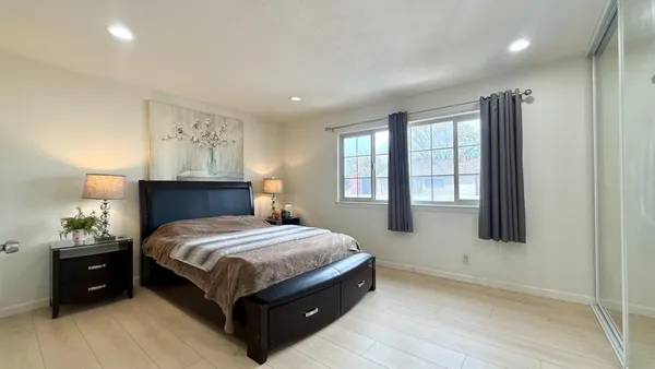 a bedroom with a bed and window