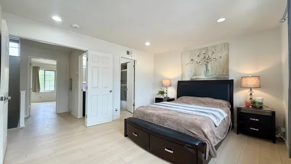 a spacious bedroom with a bed and walk in closet