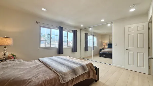 a bedroom with a large bed and a couch