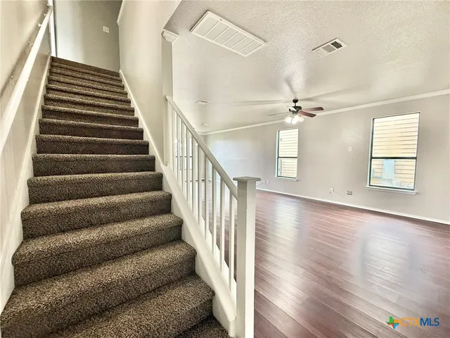 a view of entryway and hall with wooden floor