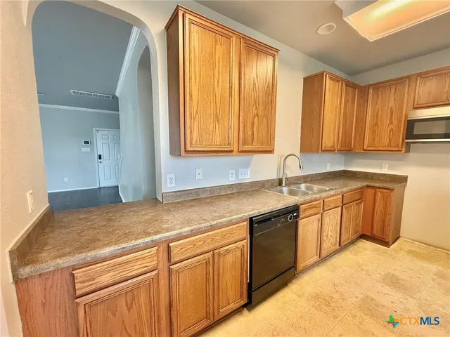 a kitchen with stainless steel appliances granite countertop a sink and a stove