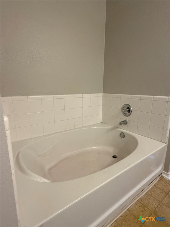 8716 Starview Street Temple, TX 76502 - Photo 8 of 20 a white bath tub sitting next to a white sink and vanity