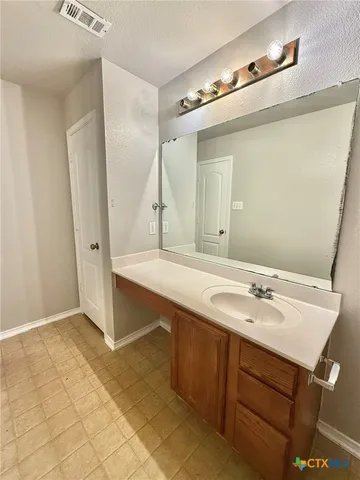 a bathroom with a sink double vanity and a mirror