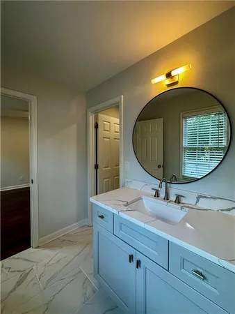 a bathroom with a sink mirror and vanity