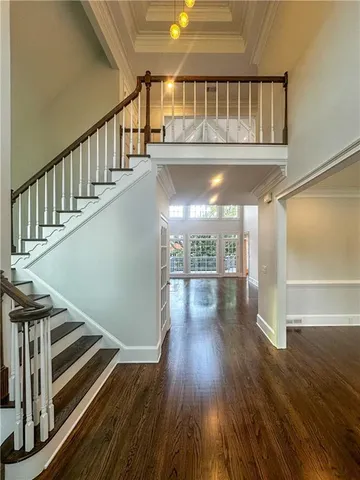 a view of entryway and hall with wooden floor