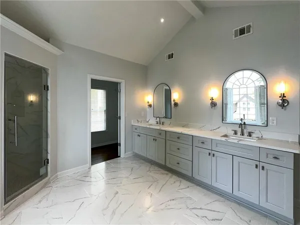 a spacious bathroom with a granite countertop sink a mirror and a