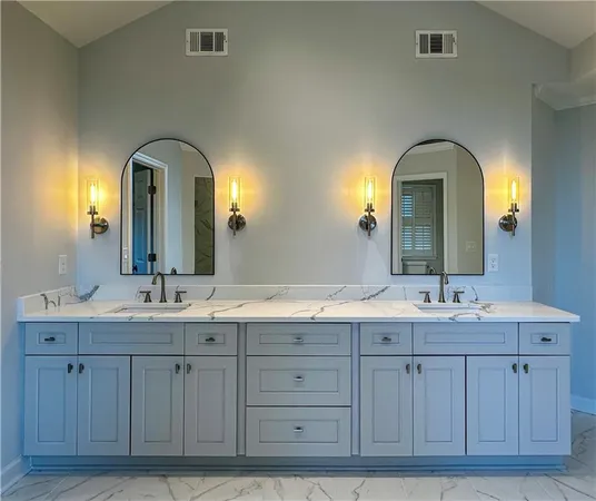 a bathroom with a double vanity sink and a large mirror