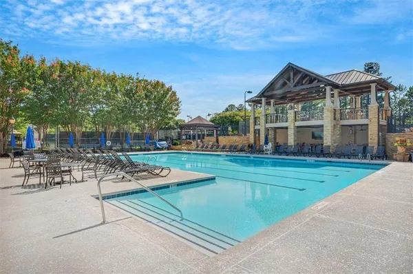 a view of a house with swimming pool and sitting area