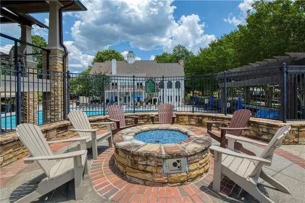 a view of a house with swimming pool and sitting area