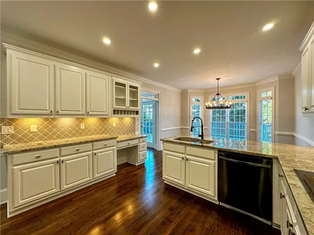 a kitchen with stainless steel appliances granite countertop a sink and stove top oven