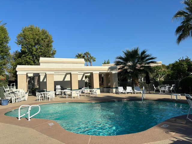 a view of a swimming pool with an outdoor seating