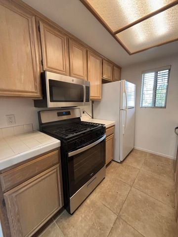 a kitchen with a stove microwave and refrigerator