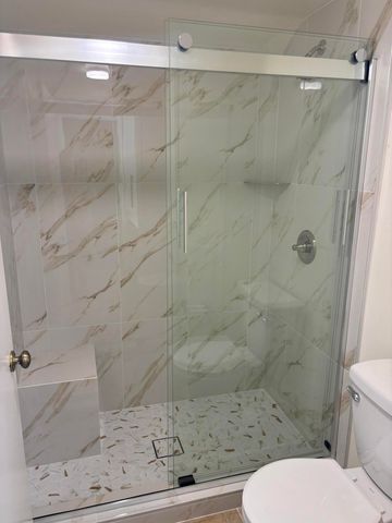 a bathroom with a toilet and a shower