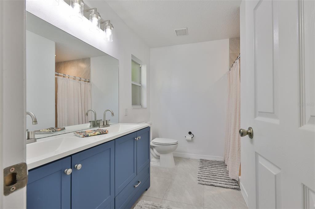 2331 West Chestnut Street Tampa, FL 33607 - Photo 18 of 33 a bathroom with a sink a toilet and a mirror