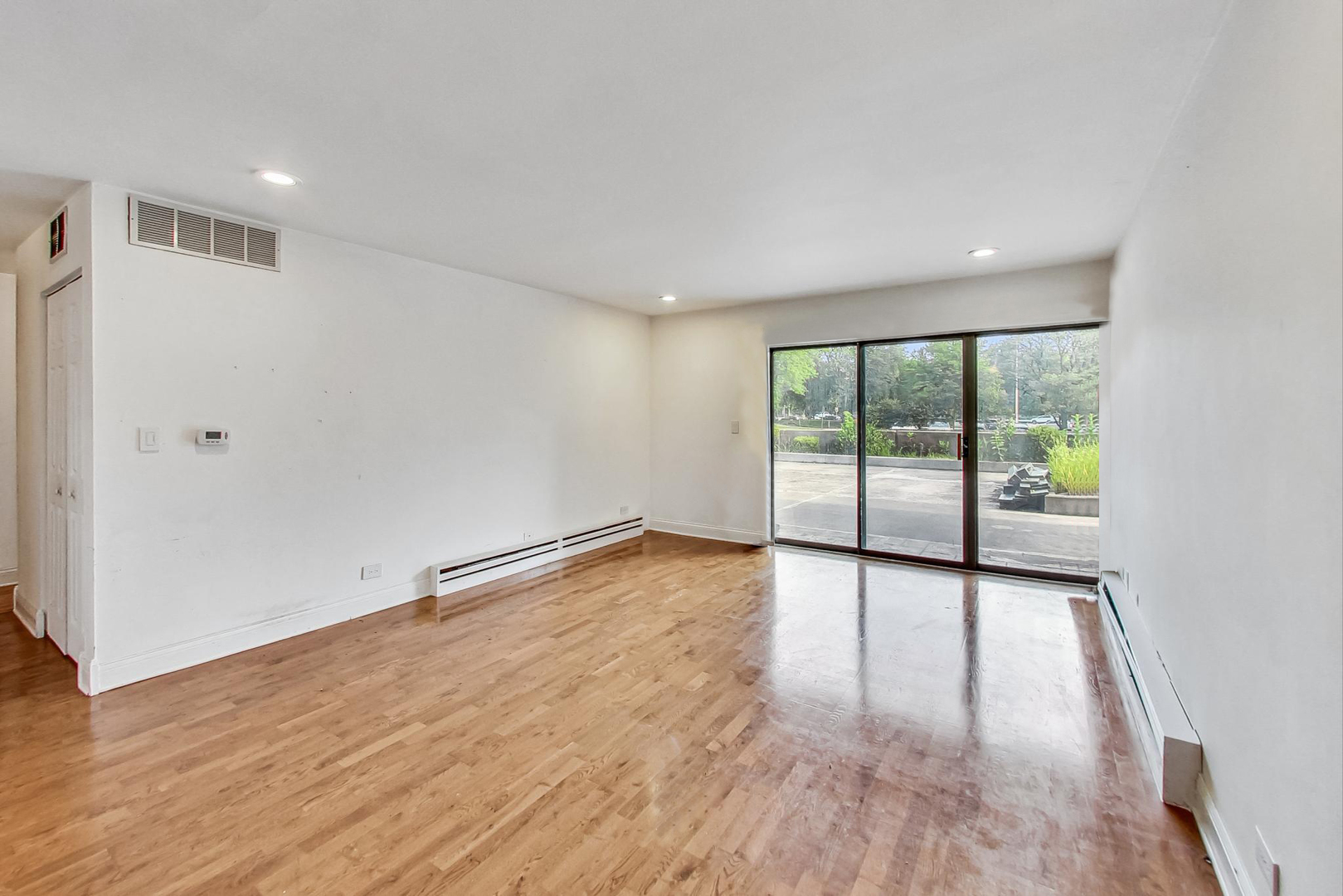 1931 Prairie Square, Unit 108 Schaumburg, IL 60173 - Photo 11 of 40 wooden floor in an empty room with a window
