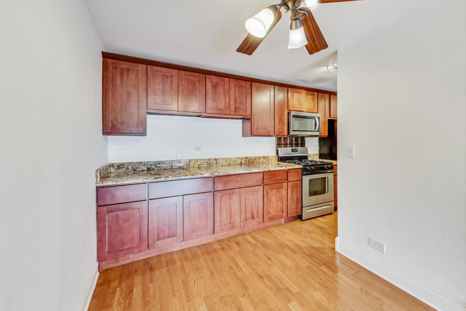 1931 Prairie Square, Unit 108 Schaumburg, IL 60173 - Photo 17 of 40 a kitchen with stainless steel appliances granite countertop a stove a sink and a refrigerator