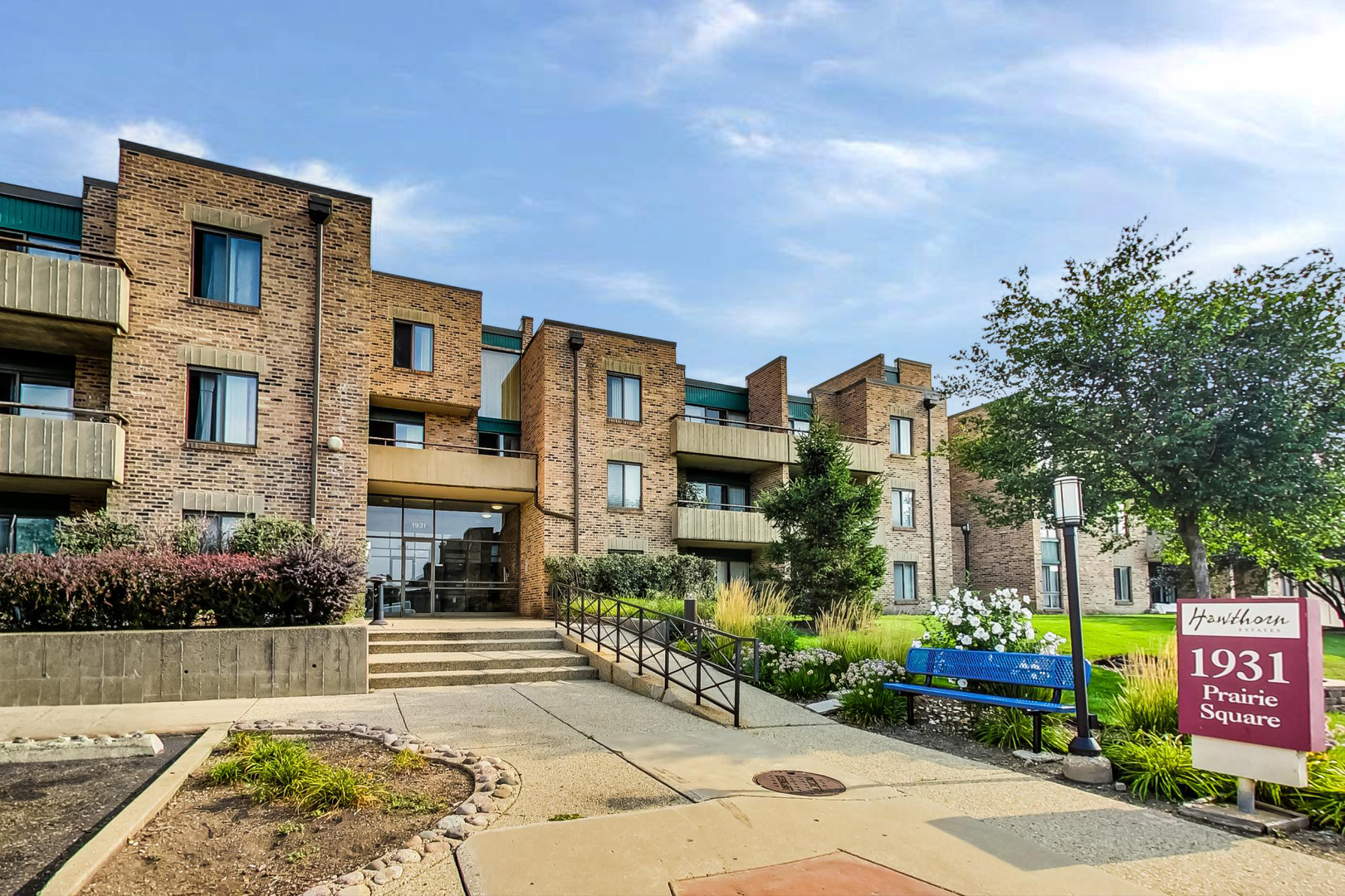 1931 Prairie Square, Unit 108 Schaumburg, IL 60173 - Photo 2 of 40 a front view of a building with garden
