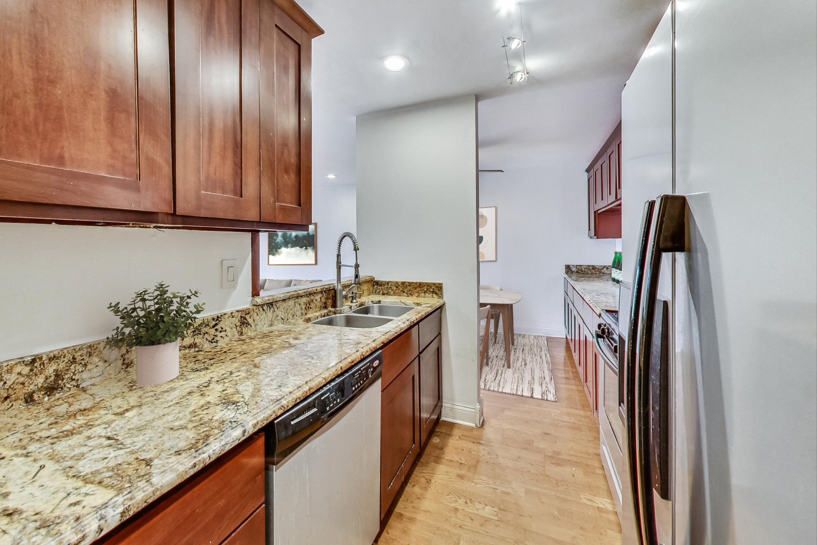 1931 Prairie Square, Unit 108 Schaumburg, IL 60173 - Photo 21 of 40 a kitchen with stainless steel appliances granite countertop a sink and a refrigerator