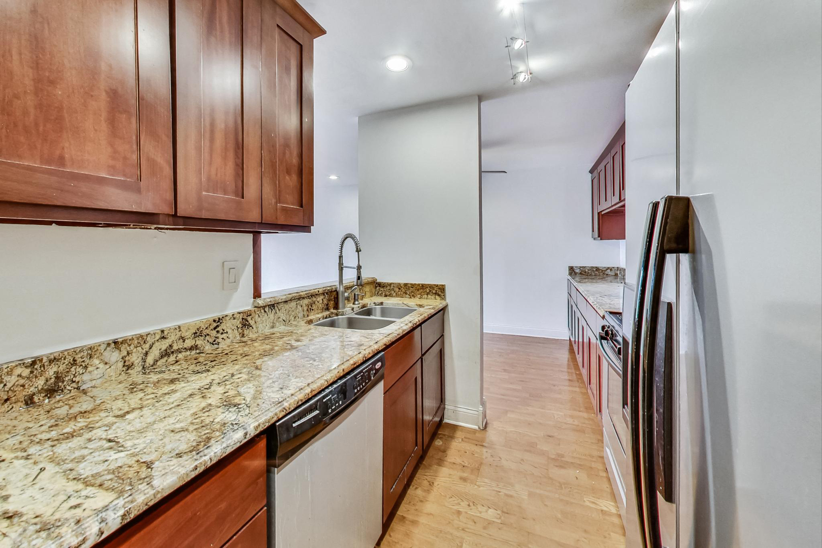 1931 Prairie Square, Unit 108 Schaumburg, IL 60173 - Photo 22 of 40 a kitchen with stainless steel appliances granite countertop a sink stove and refrigerator