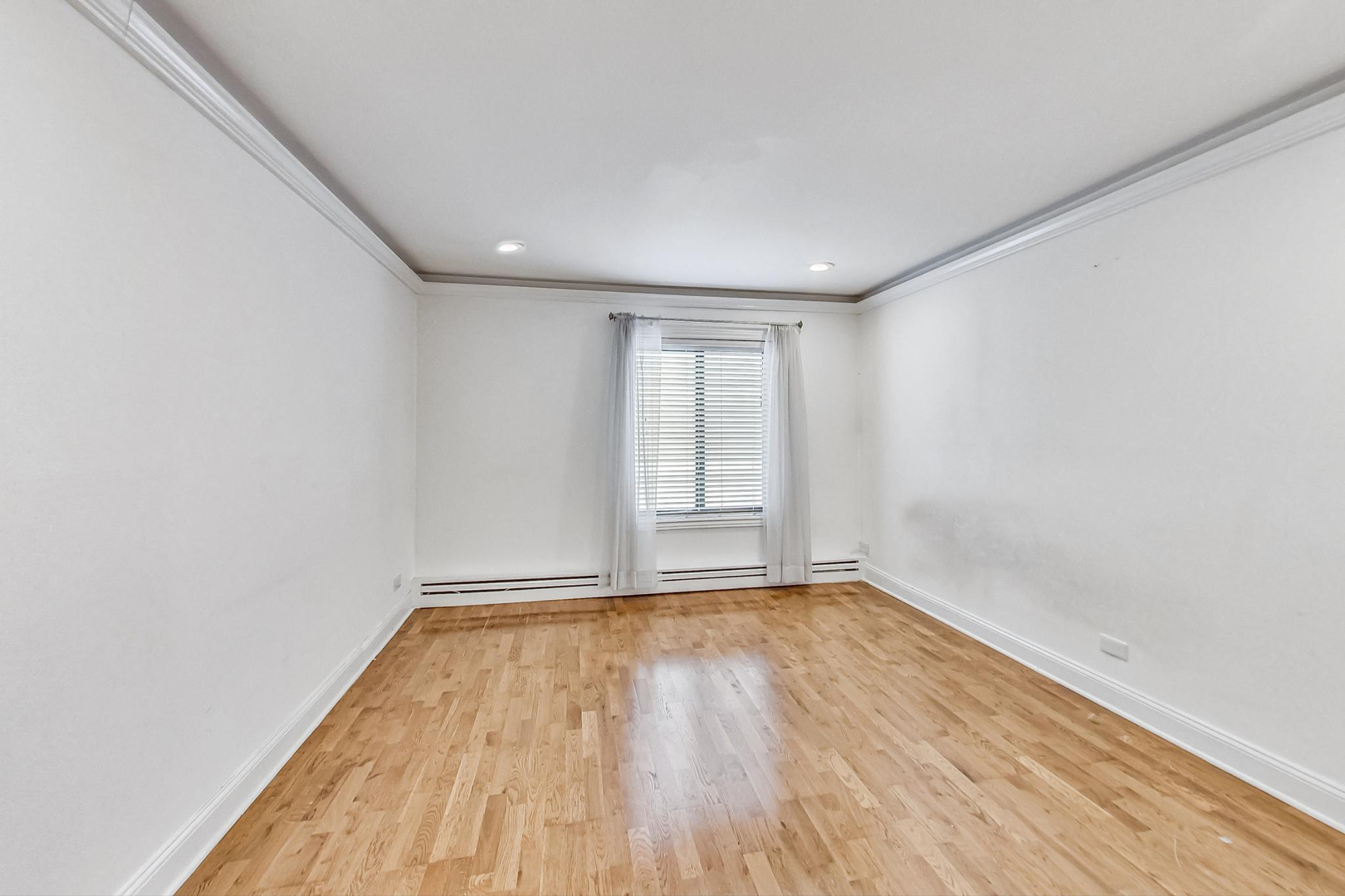 1931 Prairie Square, Unit 108 Schaumburg, IL 60173 - Photo 24 of 40 a view of an empty room with wooden floor and a window