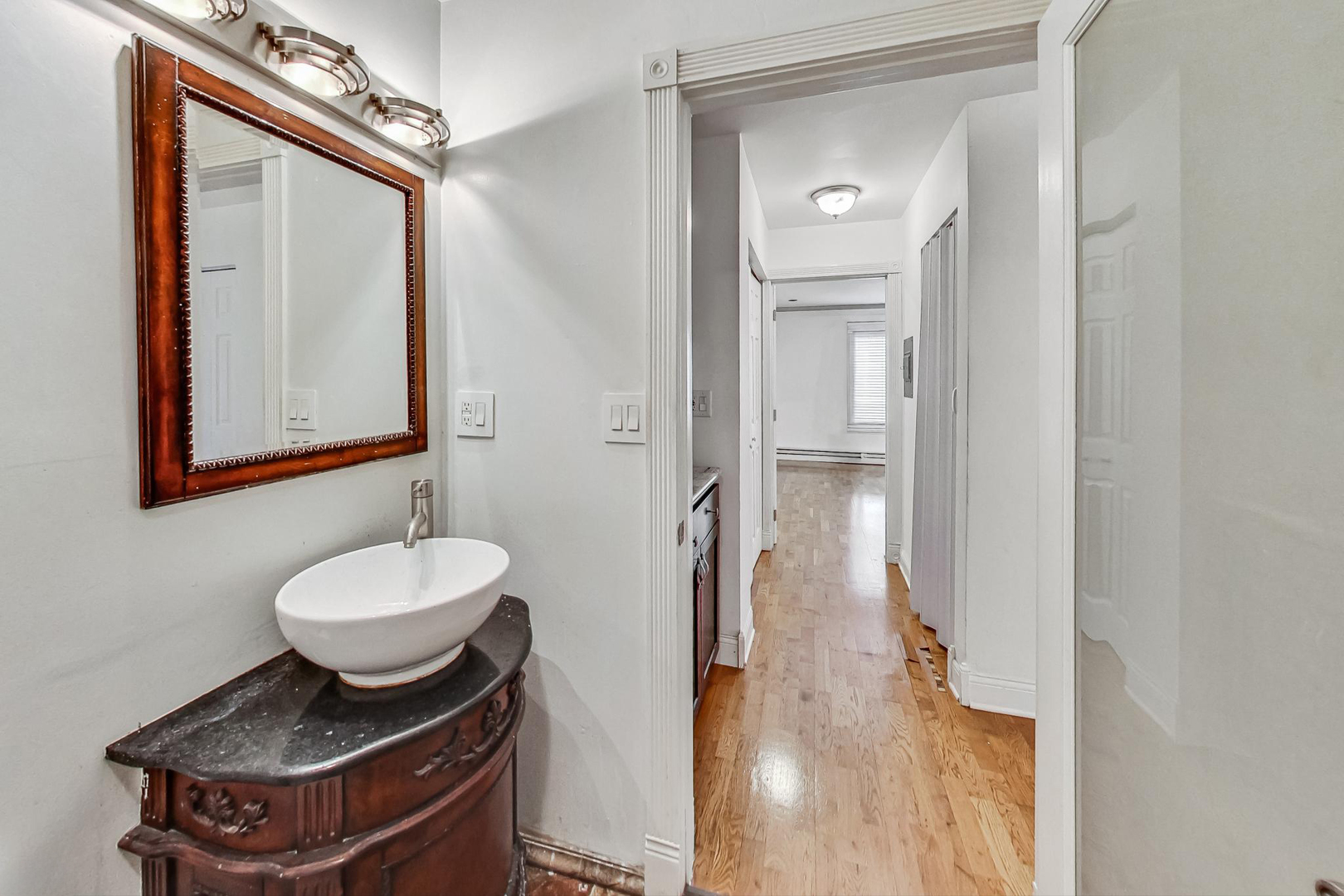 1931 Prairie Square, Unit 108 Schaumburg, IL 60173 - Photo 27 of 40 a bathroom with a granite countertop sink a toilet and mirror
