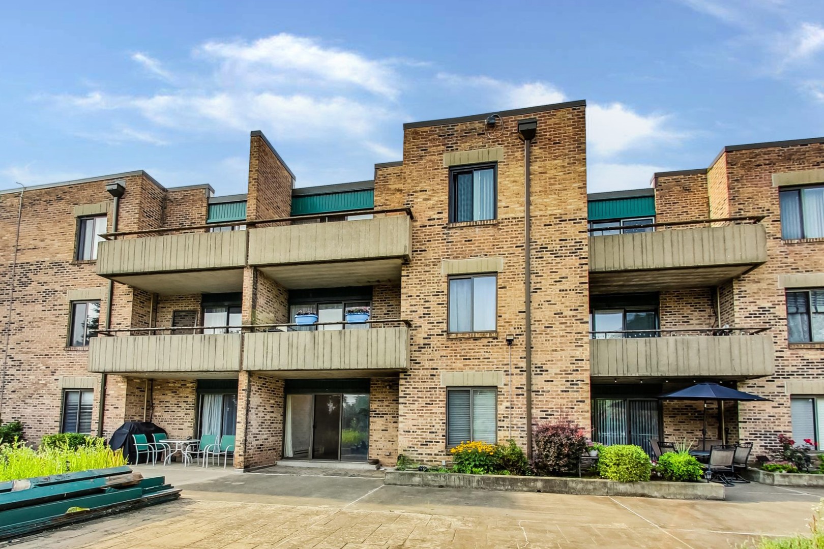 1931 Prairie Square, Unit 108 Schaumburg, IL 60173 - Photo 33 of 40 a front view of a residential apartment building with a yard