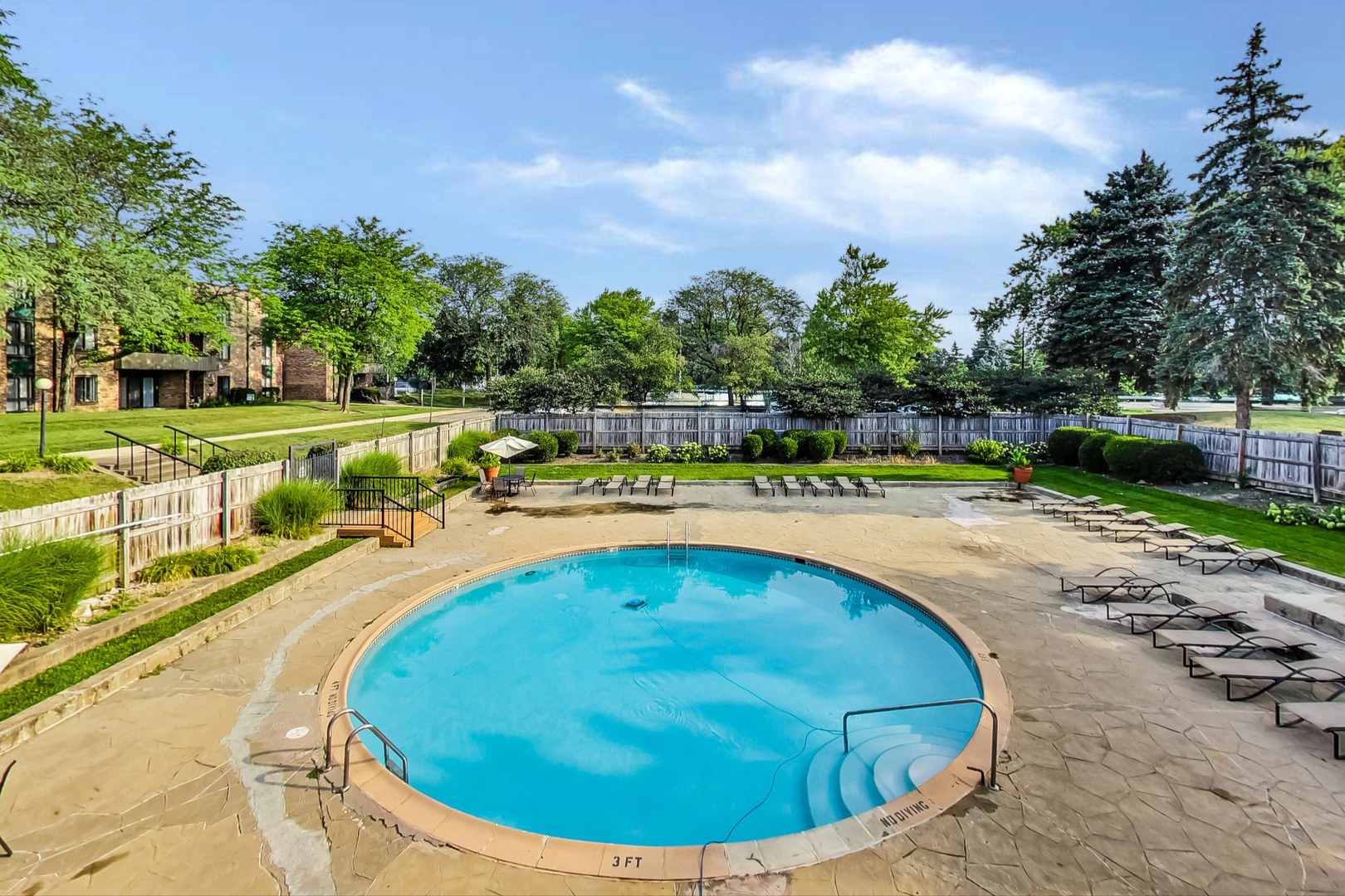1931 Prairie Square, Unit 108 Schaumburg, IL 60173 - Photo 37 of 40 a view of a swimming pool with an outdoor seating and a garden