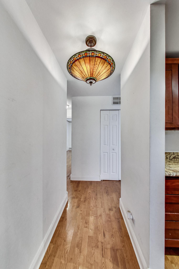 1931 Prairie Square, Unit 108 Schaumburg, IL 60173 - Photo 8 of 40 a view of kitchen with wooden floor and entryway