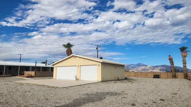 a view of a house with a snow in the background