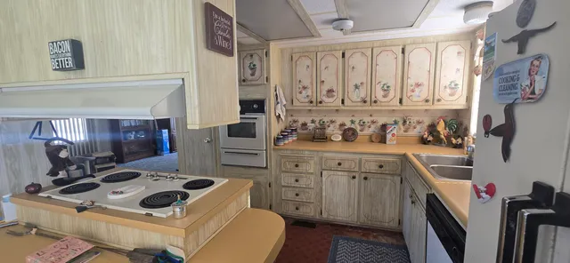 a kitchen with a stove a sink and a refrigerator