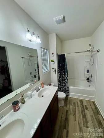 a bathroom with a tub sink and mirror