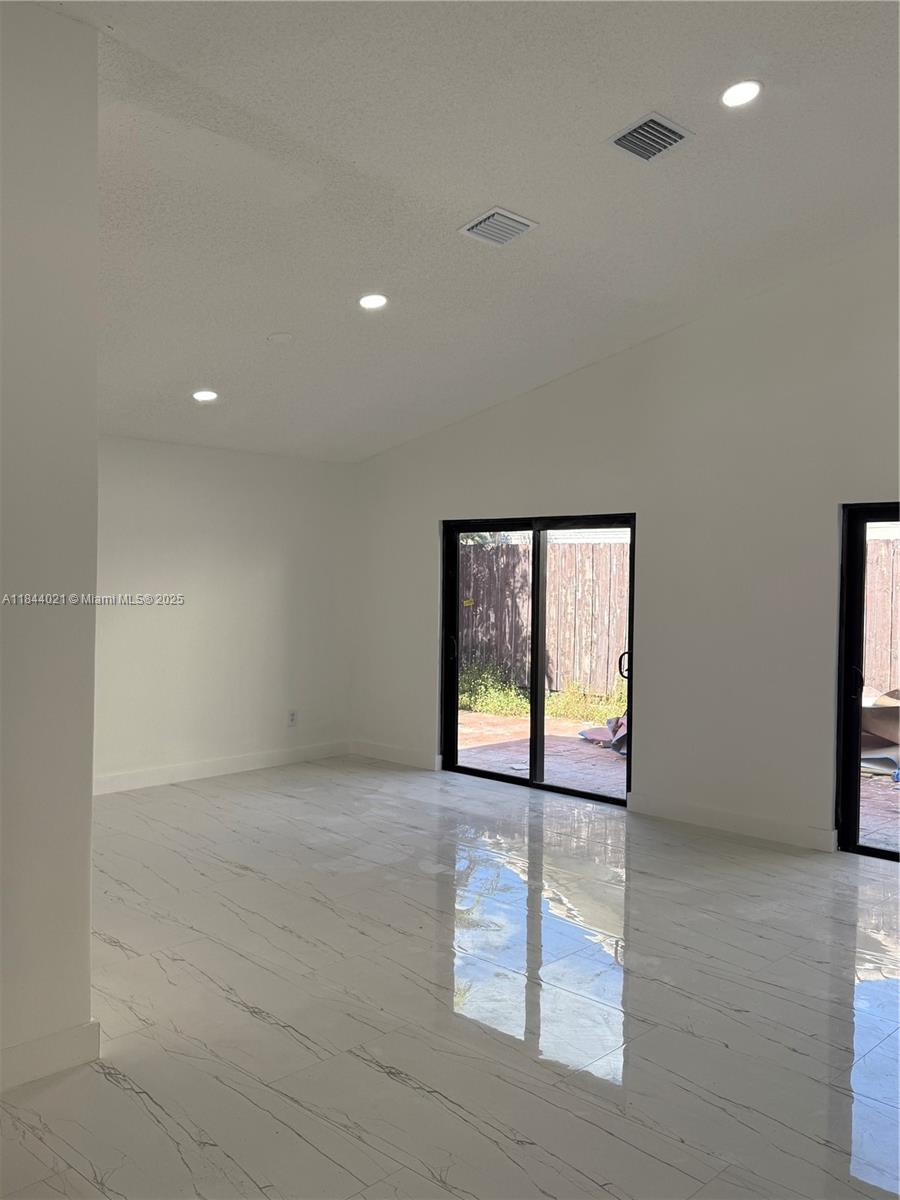 15921 Southwest 82nd Street Miami, FL 33193 - Photo 15 of 22 an empty room with windows and door