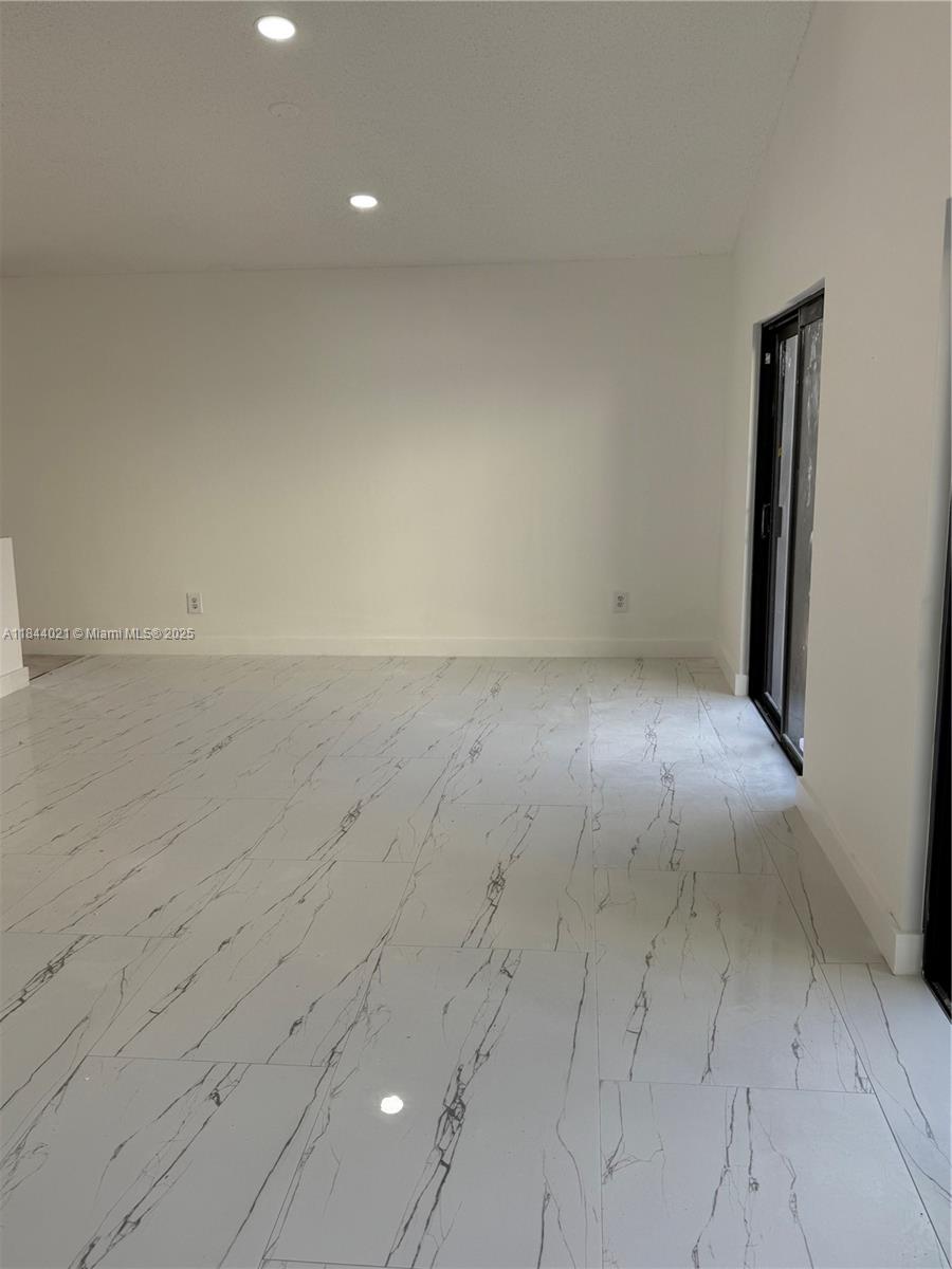 15921 Southwest 82nd Street Miami, FL 33193 - Photo 17 of 22 an empty room with a bench